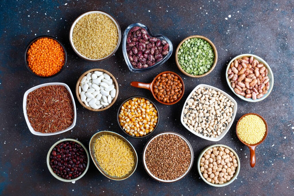 legumes beans assortment different bowls light stone background top view healthy vegan protein food