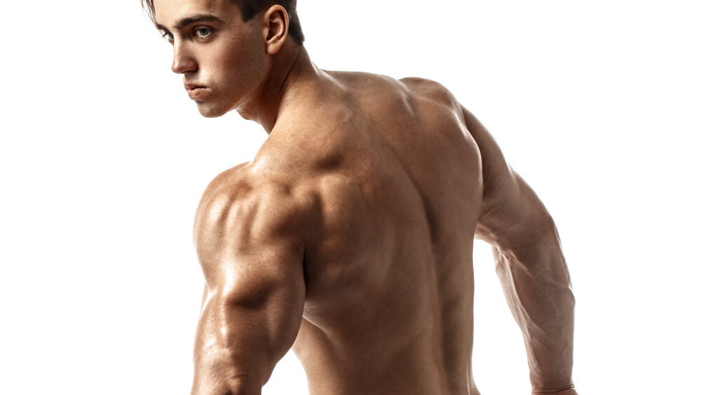 Back View Unrecognizable Man Strong Muscles Posing With Arms Down Isolate