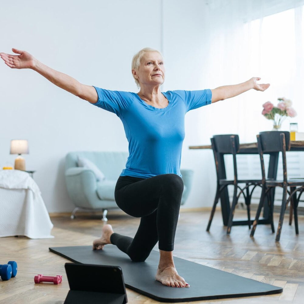 Elderly Woman Doing Exercises With Online Trainer Her Living Room Concept Online Training