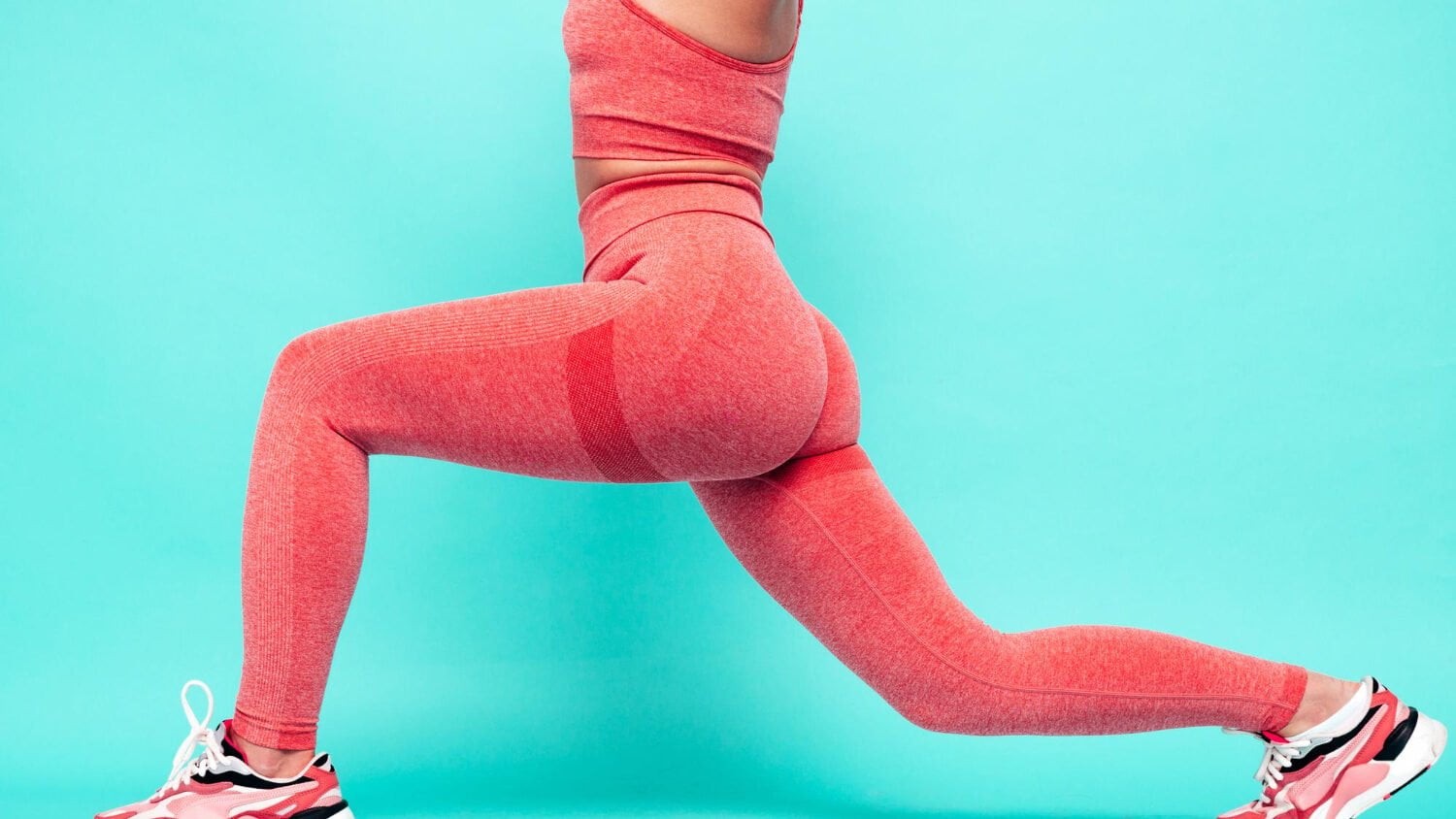 Fitness Smiling Woman Pink Sports Clothing Young Beautiful Model With Perfect Bodyfemale Posing Near Blue Wall Studiocheerful Happy Stretching Out Before Training Doing Lunges