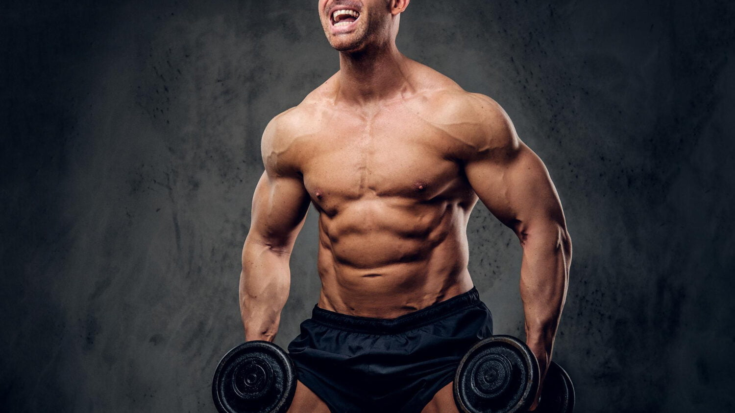 Happy Joyful Bodybuilder Is Doing Exercises With Barbels Showing His Muscules Dark Background