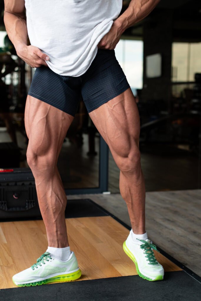 Man Gym Showing His Well Trained Legs Closeup