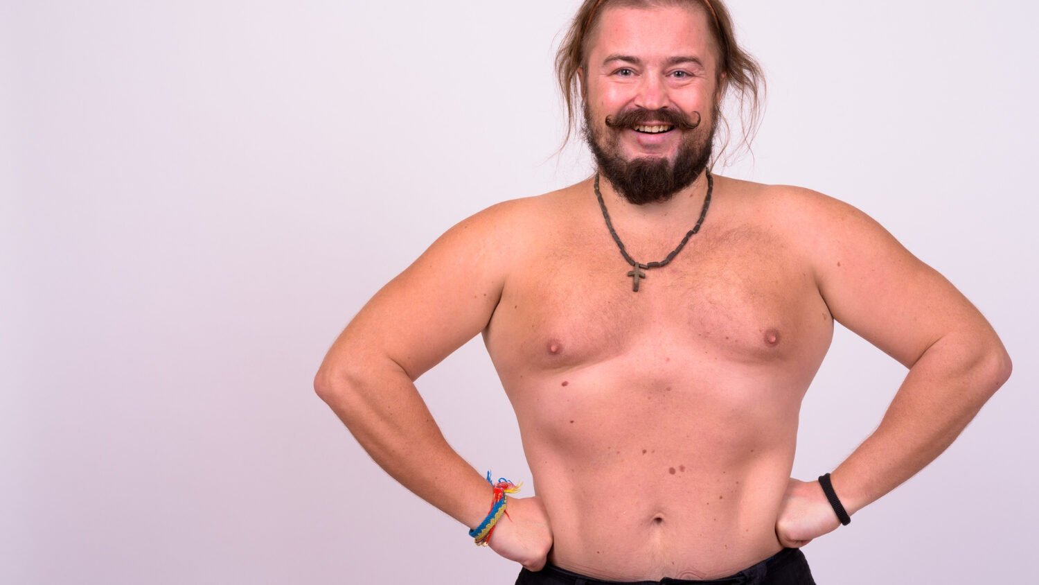 Portrait Overweight Bearded Man With Mustache Long Hair Shirtless Against White Wall