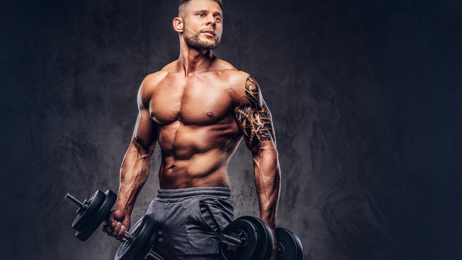 Powerful Stylish Bodybuilder With Tattoo His Arm Doing Exercises With Dumbbells Isolated Dark Background