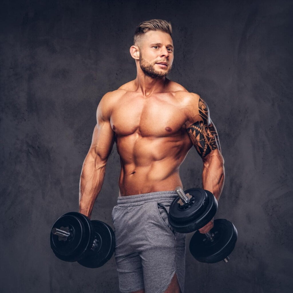 Powerful Stylish Bodybuilder With Tattoo His Arm Posing With Dumbbells Studio Isolated Dark Background