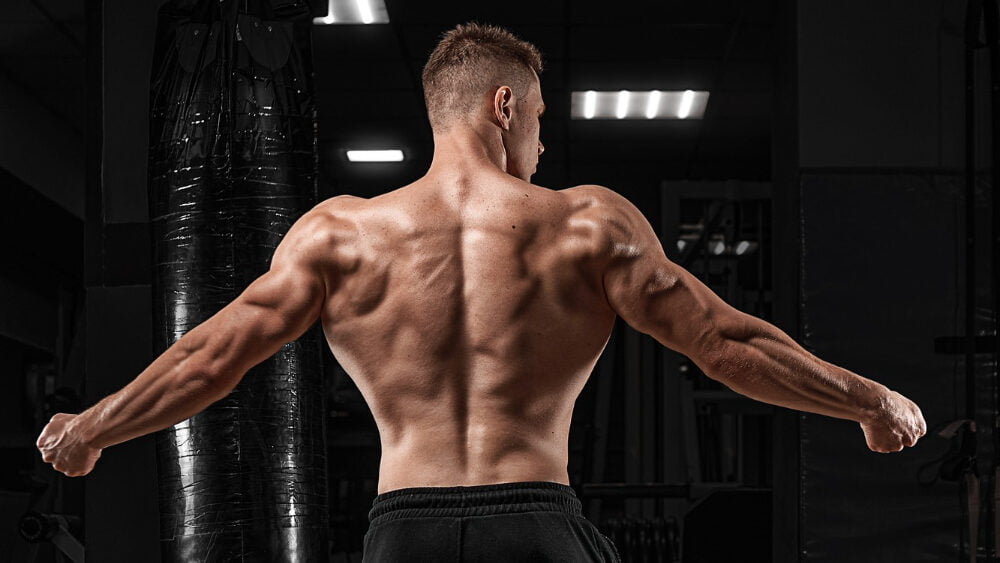 Strong Athletic Man Fitness Model Posing Back Muscles Triceps Latissimus Dark Background