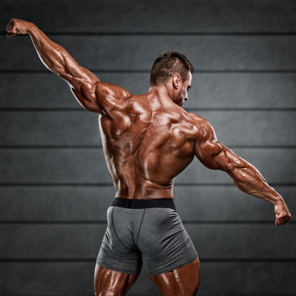 Strong Muscular Men Flexing Muscles From Back He Is Showing Back Muscles Development 1