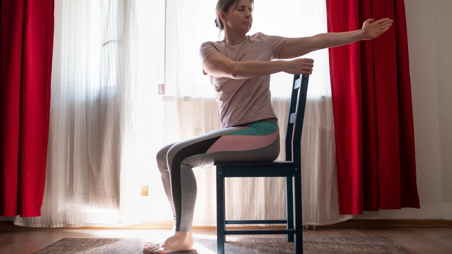 Woman Working Out Doing Yoga Pilates Exercise Using Chair